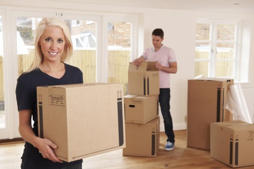 Local moving team handling packed boxes and furniture in Maida Vale