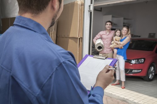 Local movers navigating stairs in a Maida Vale flat during a same-day removal