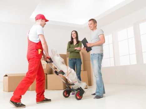 Packed moving boxes and furniture ready for flat removals in Maida Vale